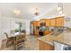Modern kitchen with stainless steel appliances, granite countertops, breakfast bar and an adjacent dining area at 2167 Kerwood Loop, The Villages, FL 32162