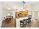 Bright kitchen featuring wood cabinets, granite countertops, stainless steel appliances, and bar stool seating at 2167 Kerwood Loop, The Villages, FL 32162