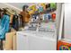 Practical laundry area with washer, dryer, and shelving for organization, maximizing space at 2167 Kerwood Loop, The Villages, FL 32162