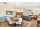 Open-concept living and dining area with ample seating, hardwood floors, and natural light at 2167 Kerwood Loop, The Villages, FL 32162