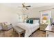Comfortable bedroom with soft natural light, cozy decor, ceiling fan, and views of the yard at 2167 Kerwood Loop, The Villages, FL 32162