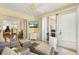 Relaxing sunroom with neutral decor, comfortable seating, and views of the well-manicured backyard at 2167 Kerwood Loop, The Villages, FL 32162