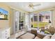 Cozy sunroom with ample natural light, comfortable seating, and views of the well-maintained backyard at 2167 Kerwood Loop, The Villages, FL 32162