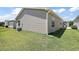 Backyard with well-maintained lawn and vinyl siding in a peaceful neighborhood at 2296 Whisper St, The Villages, FL 32162