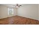 Bright bedroom featuring hardwood floors, natural light, and a ceiling fan at 2296 Whisper St, The Villages, FL 32162