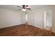 Spacious bedroom with hardwood floors, ceiling fan, and ensuite bathroom for easy access at 2296 Whisper St, The Villages, FL 32162