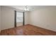 Bedroom with wood floor, white walls, a ceiling fan, and a window with natural light at 2296 Whisper St, The Villages, FL 32162