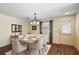 Bright dining area with modern table set, chandelier and a large window at 2296 Whisper St, The Villages, FL 32162
