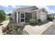 Charming home with a cozy screened-in patio and well-maintained landscaping at 2296 Whisper St, The Villages, FL 32162