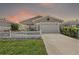 Charming single story home with well-manicured lawn, picket fence, and inviting curb appeal at 2296 Whisper St, The Villages, FL 32162