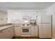 Bright kitchen featuring white cabinets, modern appliances, and hardwood floors at 2296 Whisper St, The Villages, FL 32162