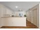 Bright open kitchen with white cabinetry, breakfast bar and a stylish view at 2296 Whisper St, The Villages, FL 32162