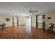 Cozy living room boasts hardwood floors, ample lighting, and a ceiling fan, for a warm and inviting space at 2296 Whisper St, The Villages, FL 32162