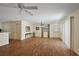 Well-lit living room displays hardwood floors, fan, and natural light, enhancing the room's comfort at 2296 Whisper St, The Villages, FL 32162