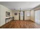 Bright living room featuring hardwood floors, neutral walls, and modern lighting fixture at 2296 Whisper St, The Villages, FL 32162