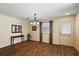 Bright living room featuring hardwood floors, neutral walls, and modern lighting fixture at 2296 Whisper St, The Villages, FL 32162