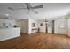 Open concept living room showcases hardwood floors, a fan, and a door to the backyard at 2296 Whisper St, The Villages, FL 32162