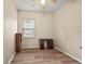 Cozy bedroom with wood-look floors, a window, and a small desk at 24346 Amberleaf Ct, Leesburg, FL 34748
