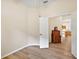 Bedroom with wood-look floors and a doorway leading to additional living spaces at 24346 Amberleaf Ct, Leesburg, FL 34748