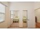 Mirrored closet doors in a bedroom reflect the twin beds and decor at 24346 Amberleaf Ct, Leesburg, FL 34748