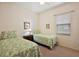 Cozy bedroom with twin beds and side table at 24346 Amberleaf Ct, Leesburg, FL 34748