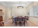 Bright dining room featuring modern chandelier and seating for six at 24346 Amberleaf Ct, Leesburg, FL 34748