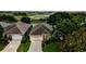Stunning exterior view of a single-Gathering home featuring well-manicured landscaping and a private driveway at 24346 Amberleaf Ct, Leesburg, FL 34748