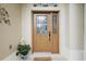 Inviting front door entrance featuring a decorative welcome mat and potted plants adding a warm touch at 24346 Amberleaf Ct, Leesburg, FL 34748