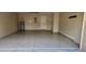 Clean garage with epoxy flooring, neutral walls, and access door at 24346 Amberleaf Ct, Leesburg, FL 34748