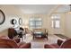 Charming living room featuring floral sofa, piano, and ample seating perfect for relaxation and conversation at 24346 Amberleaf Ct, Leesburg, FL 34748