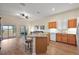 Open-concept living area featuring a kitchen island and a cozy seating area, perfect for relaxation at 24346 Amberleaf Ct, Leesburg, FL 34748