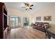 Spacious living room area featuring a sliding door providing ample natural light and backyard views at 24346 Amberleaf Ct, Leesburg, FL 34748