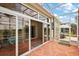 Enclosed patio featuring views of the backyard and adjacent outdoor seating areas at 24346 Amberleaf Ct, Leesburg, FL 34748