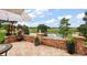 Brick paved patio offering serene views of the water and lush greenery, perfect for outdoor relaxation at 24346 Amberleaf Ct, Leesburg, FL 34748