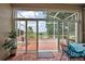 Enclosed patio with a view of lush greenery and a tranquil pond at 24346 Amberleaf Ct, Leesburg, FL 34748