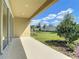 A covered back porch with views of the green lawn and garden areas at 2675 Ridgetop Ln, Clermont, FL 34711