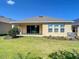 View of backyard with sliding door and landscaping at 2675 Ridgetop Ln, Clermont, FL 34711