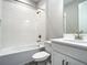 Bathroom featuring white tile shower-tub, sink, and modern fixtures at 2675 Ridgetop Ln, Clermont, FL 34711