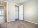 Cozy bedroom with plush carpet, closet, and view to adjacent room at 2675 Ridgetop Ln, Clermont, FL 34711