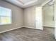 Comfortable bedroom with window, neutral paint, and wood-look tile flooring at 2675 Ridgetop Ln, Clermont, FL 34711
