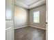 Bright bedroom with tray ceiling, wood-look tile flooring, and large window at 2675 Ridgetop Ln, Clermont, FL 34711