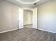 Spacious bedroom featuring double doors, neutral paint, and wood-look tile flooring at 2675 Ridgetop Ln, Clermont, FL 34711