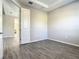 A bedroom with grey wood-look tile, neutral paint, and a tray ceiling at 2675 Ridgetop Ln, Clermont, FL 34711