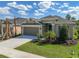 Charming single-Gathering home features a two-car garage, well-manicured lawn, and lush landscaping at 2675 Ridgetop Ln, Clermont, FL 34711