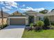 Attractive single-Gathering home featuring a two-car garage, pristine lawn, and vibrant landscaping at 2675 Ridgetop Ln, Clermont, FL 34711