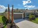 Inviting single-Gathering home with a spacious driveway, two-car garage, and professionally landscaped front yard at 2675 Ridgetop Ln, Clermont, FL 34711