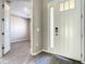 Foyer with white door, sidelight, wood-look tile flooring, and views into adjacent rooms at 2675 Ridgetop Ln, Clermont, FL 34711