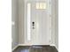 Modern front door with sidelight, smart lock, and wood-look tile flooring at 2675 Ridgetop Ln, Clermont, FL 34711