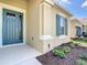 Inviting front door featuring sidelight and decorative window inserts, complemented by well-maintained landscaping at 2675 Ridgetop Ln, Clermont, FL 34711