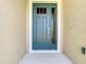 Exterior front door showcasing sidelight and stylish design in a new home at 2675 Ridgetop Ln, Clermont, FL 34711